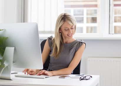 Candid portrait of young creative woman working with computer